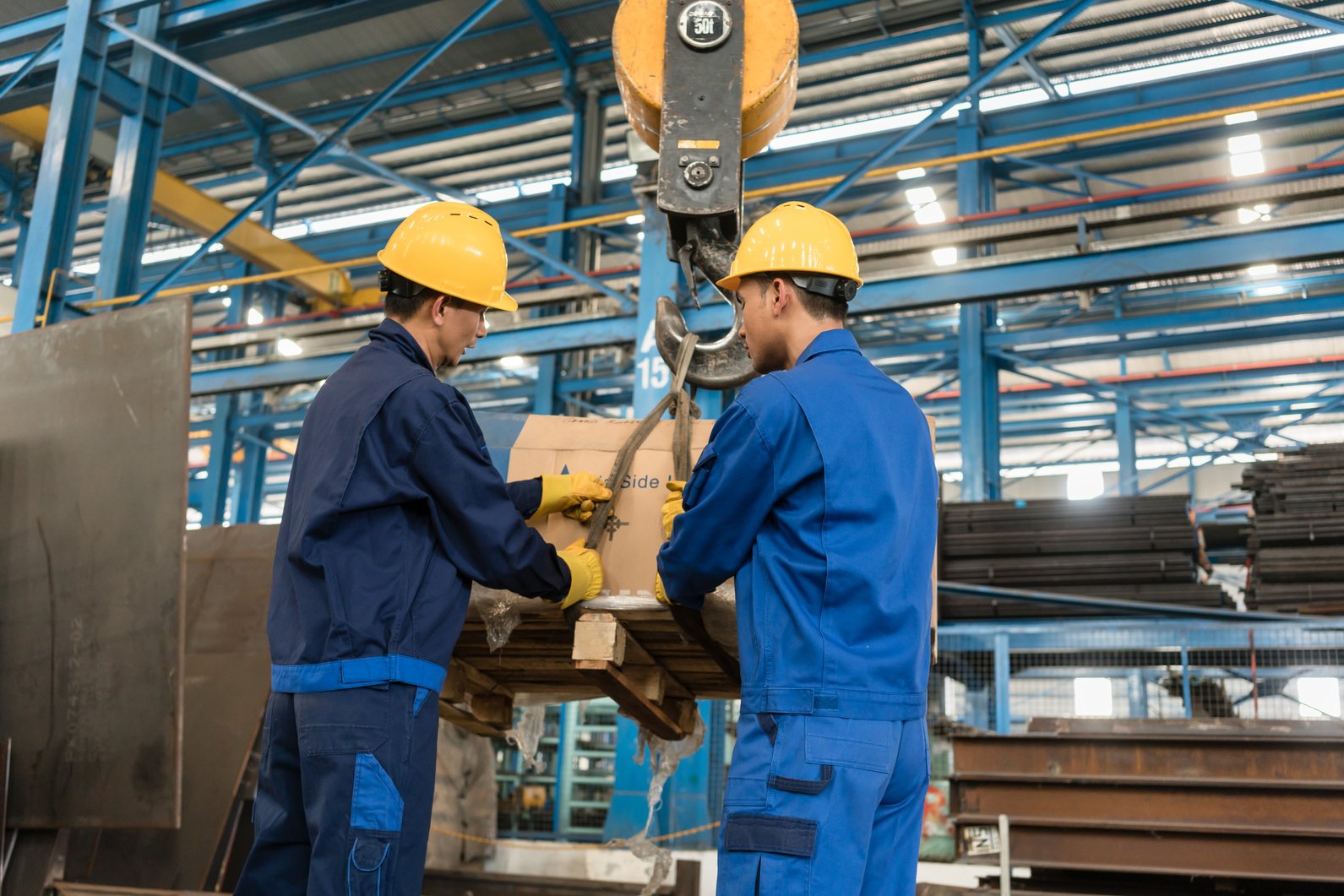 Two Workers Handling Heavy Loading 